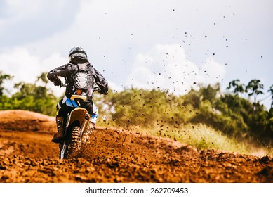 Motocross Racer Accelerating In Dirt Track