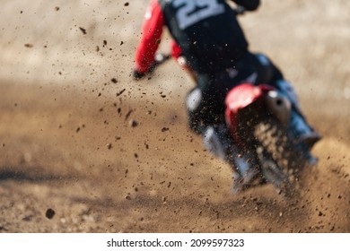 Motocross Rider Creates A Huge Cloud Of Dust And Stone, Flying Debris From A Motocross In Dirt Track