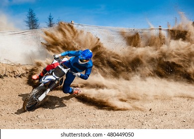 Motocross rider creates a large cloud of dust and debris - Shutterstock ID 480449050