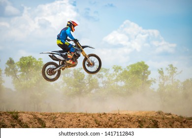 Motocross Rider Jump in a blue sky with clouds.Enduro bike rider in action.  - Powered by Shutterstock