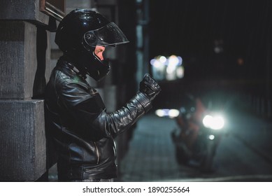 Motor Biker In The Black Leather Jacket On The City Street At Night.