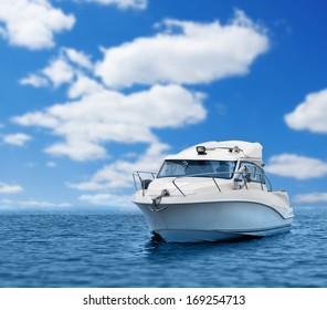 Motor boat in blue sea or ocean, cloud sky.