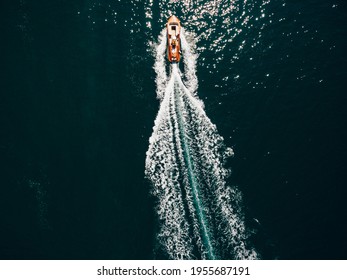 The Motor Boat Is Cutting Through The Sea Water. Drone Photo, Top View.