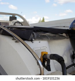 Motor Boat Fueling, Fuel Gun With Hose In Transom Filler Cap On Blue Sky Background