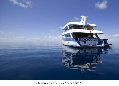 Motor boat on clear turquoise water... maldives
