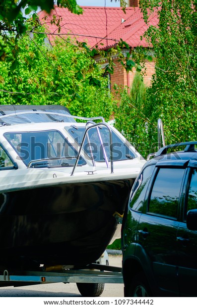 Motor boat on a trailer with a car. The concept
of summer holidays.