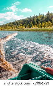 A Motor Boat With A Paddle On Board Makes A Sharp Turn With Traces Of Foam And Splashes With A View Of The Shore And The Forest Bright Sunny Day On The River