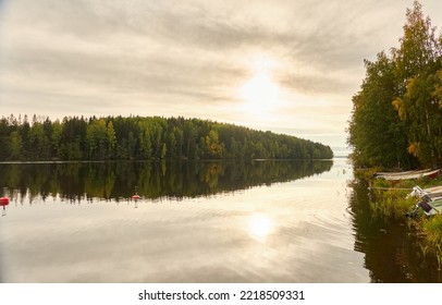 Motor boats, cutters and small fishing boats standing on land near the evergreen forest. Suiro lake (Kulovesi), Finland. Nature, ecotourism, hiking concepts - Powered by Shutterstock