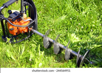 Motor Earth Auger On The Grass