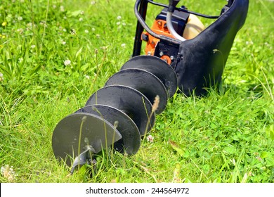 Motor Earth Auger On The Grass