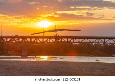 A Motor Glider At Sunset Over The Bridge