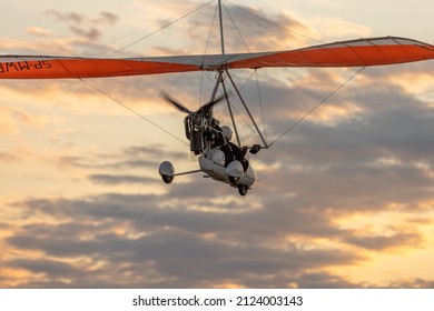 A Motor Glider At Sunset Over The Bridge