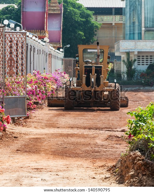 Motor\
grader in the temple for construct the car\
park.