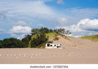 A Motor Home Is Parked  Near Lake Michigan And The Dunes, In Michigan USA