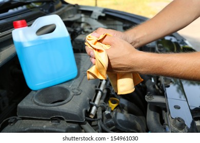 Motor Mechanic Cleaning His Greasy Hands After Servicing Car 