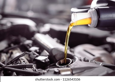 Motor Oil Pouring To Car Engine.