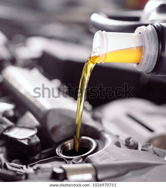 Motor oil pouring to car
engine.