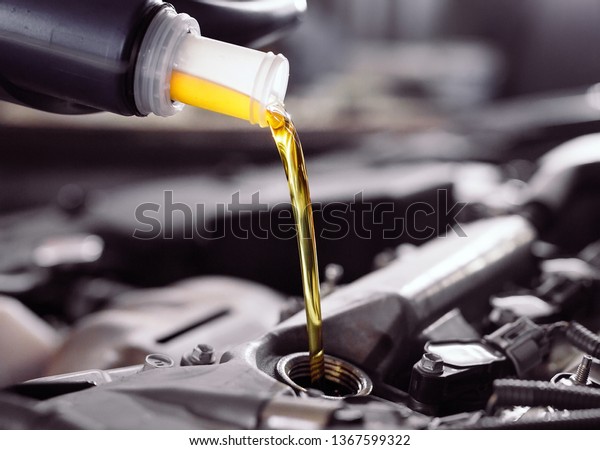 Motor oil pouring to car
engine.
