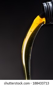 Motor Oil Pouring Over Black Background