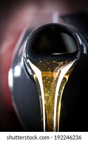 Motor Oil Pouring Over Black Background