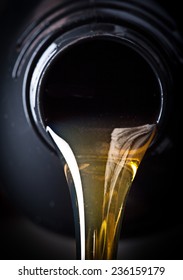 Motor Oil Pouring Over Black Background