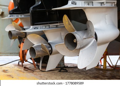 Motor Propellers For Motor Yachts And Boats Close-up. The Motors Are Mounted At The Stern Of The Motor Boat. Repair A Boat In A Dry Dock.