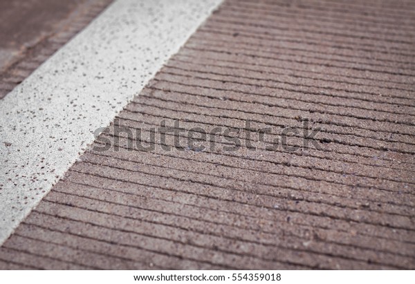 Motor racing circuit Red and White. White and\
red strip no Parking Sign on Footpath road. Road sign. Red and\
White sign on road. Motor race asphalt. white and red of concrete\
road texture background.