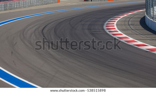 Motor racing track. Turning asphalt road with
marking lines
