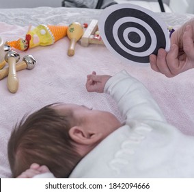 Motor Skills And Early Stimulation Class With Baby And Contrasting Black And White Pictures