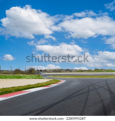 Motor sport asphalt race track and curbs with skid marks, low angle view