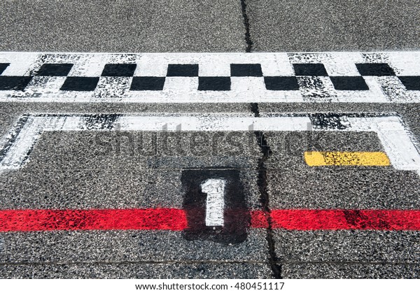 Motor sport starting line pole position sign on\
asphalt track