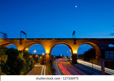 Motor tail lights on the motorway passing under Stockport viaduct tin greater Manchester