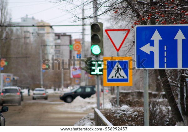 Motor transport crossroads in the\
city with traffic lights and road signs, focus on\
sign