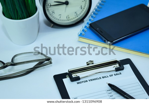 Motor Vehicle Bill of Sale Planning on Background of\
Working Table with Office Supplies. Business and Schedule Concept\
Planning on White Desk