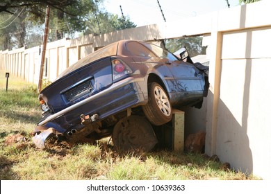 A Motor Vehicle Car Crashed Through A Brick Wall At High Speed