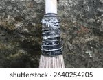 motor vehicle tire strips and rubber tape to tie the coconut leaf blades to the bamboo handle.