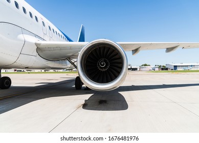 Motor and a wing of an aircraft plane at the airport. Airline, aeronautics, and travelling concept.