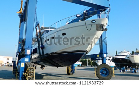 motor yacht is raised with a special crane for repair