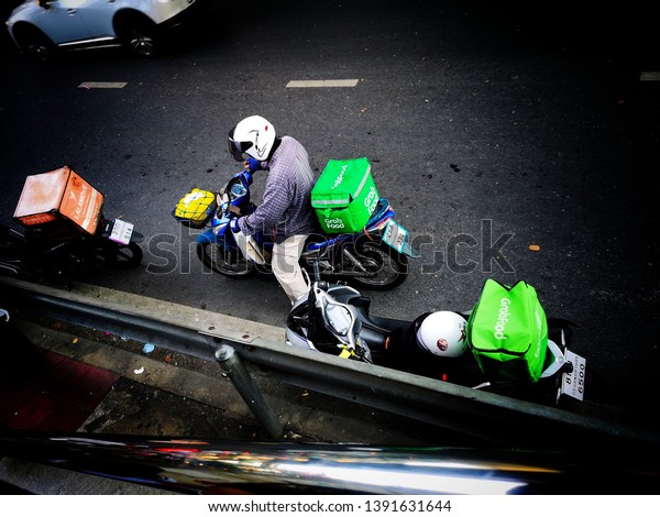 Motorbike of the delivery staff in\
busy traffic and traffic jams in Bangkok, Thailand, May\
2019