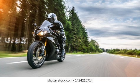 motorbike on the road driving fast. having fun on the empty highway on a motorcycle  journey. copyspace for your individual text. - Shutterstock ID 1424213714