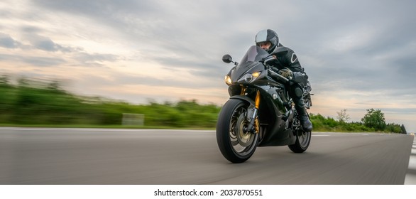 motorbike on the road driving fast. having fun on the empty highway on a motorcycle  journey. copyspace for your individual text. - Shutterstock ID 2037870551
