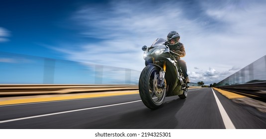 motorbike on the road fast driving. having fun driving the empty road on a motorcycle tour journey. copyspace for your individual text. motion blur shot