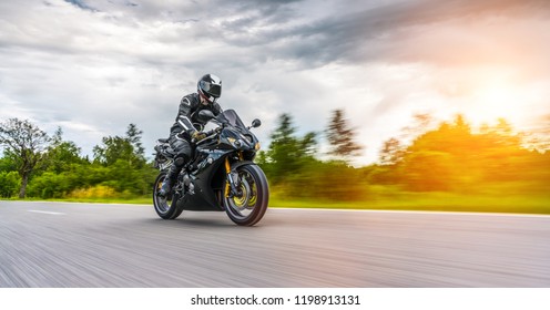 motorbike on the road riding. having fun driving the empty road on a motorcycle tour journey. copyspace for your individual text. - Shutterstock ID 1198913131
