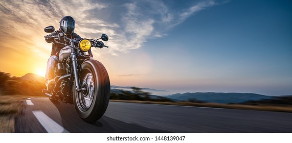 motorbike on the road riding. having fun driving the empty highway on a motorcycle tour journey. copyspace for your individual text. - Shutterstock ID 1448139047