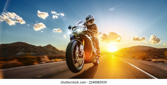 motorbike on the road riding. having fun driving the empty road on a motorcycle tour journey. copyspace for your individual text. - Shutterstock ID 2240085929