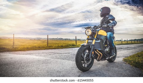 motorbike on the road riding. having fun driving the empty road on a motorcycle tour journey. copyspace for your individual text. - Shutterstock ID 615445055