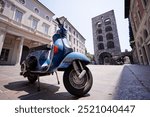 Motorbike outdoor. Blue retro-style scooter on town street.