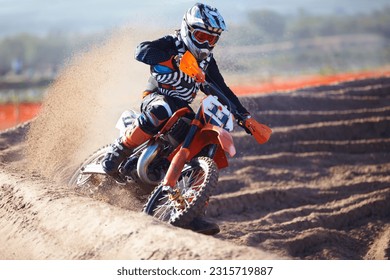 Motorbike, sport and action with dirt for competition with power or speed on course for transportation. Race, bike and professional driver in desert for adventure or sports at a rally with energy.