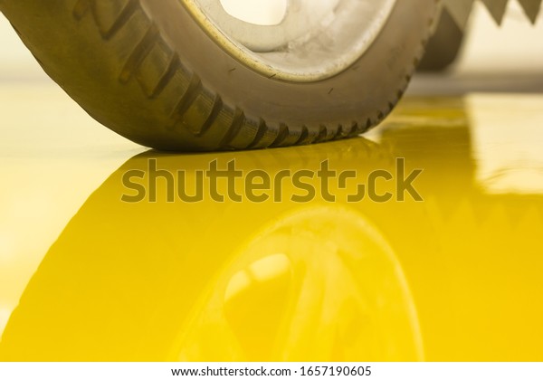 Motorbike wheel on the
yellow epoxy floor