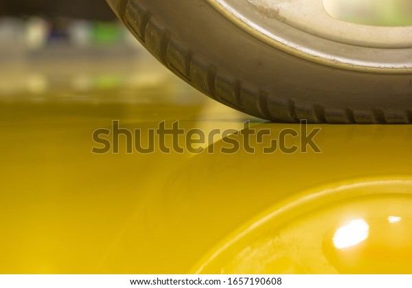 Motorbike wheel on the
yellow epoxy floor